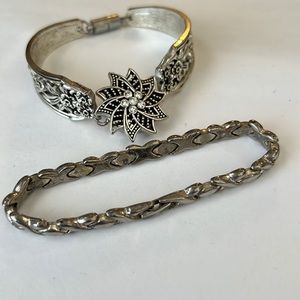 Two silver colored bracelets